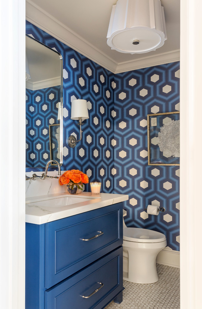 Photo of a mid-sized traditional powder room in Little Rock with raised-panel cabinets, blue cabinets, ceramic floors, marble benchtops and white benchtops.