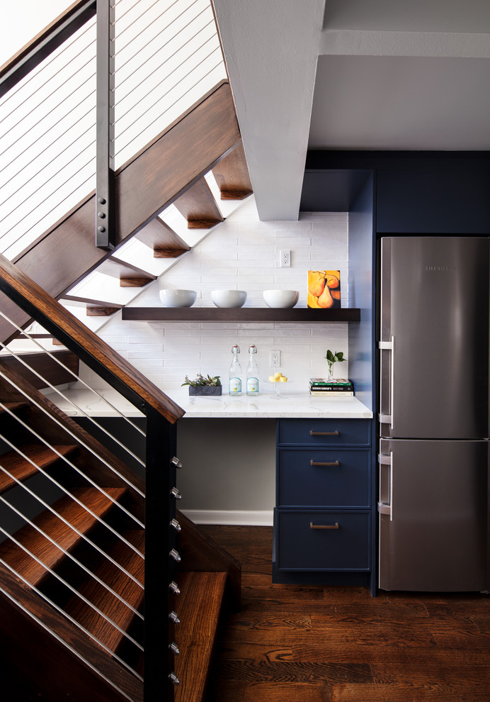 Small transitional dark wood floor and brown floor kitchen photo in New York with a farmhouse sink, blue cabinets, white backsplash, ceramic backsplash, colored appliances and no island