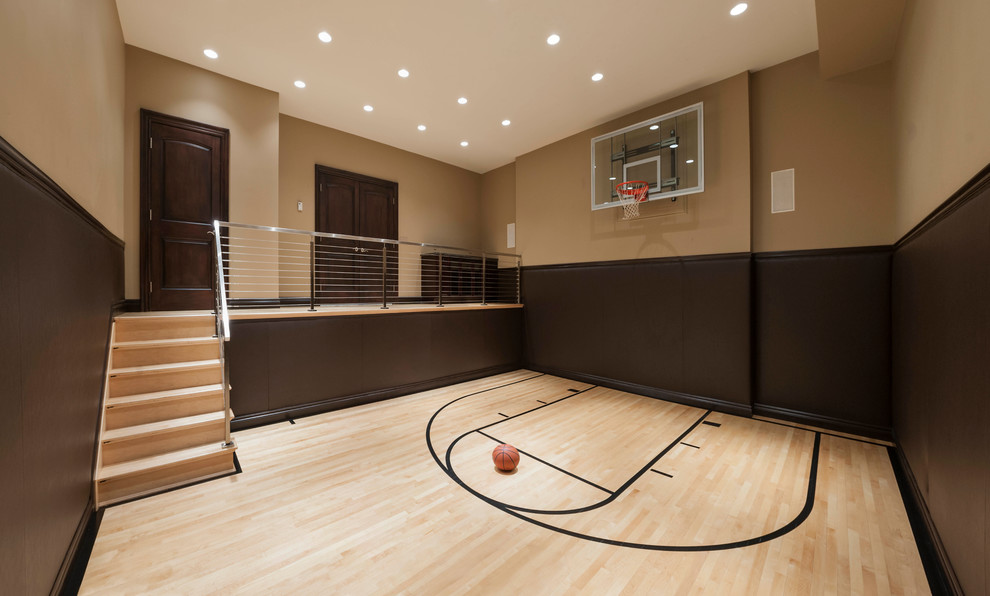 This is an example of a large traditional indoor sport court in Detroit with brown walls, light hardwood floors and beige floor.