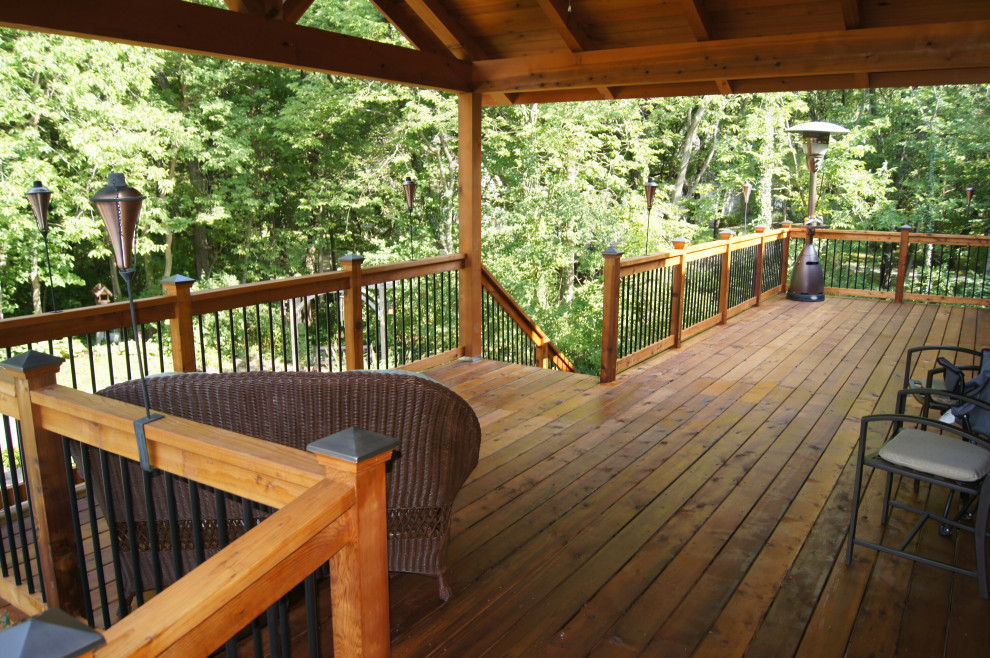 Inspiration for an expansive backyard deck in Other with a roof extension.