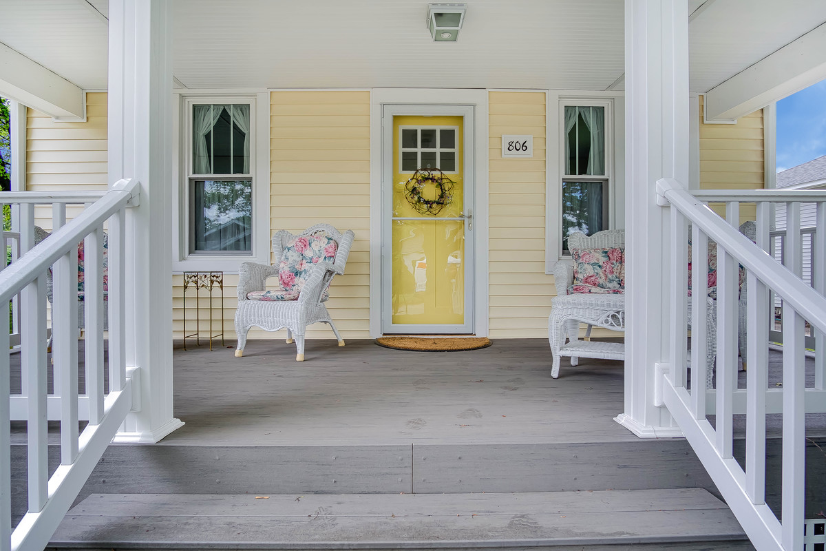 Design ideas for a small traditional one-storey yellow apartment exterior in Grand Rapids with wood siding.