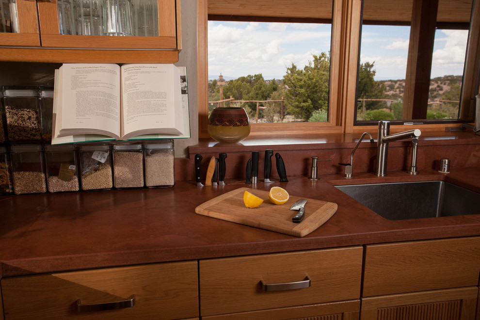 Mountain style kitchen photo with brown backsplash and stainless steel appliances