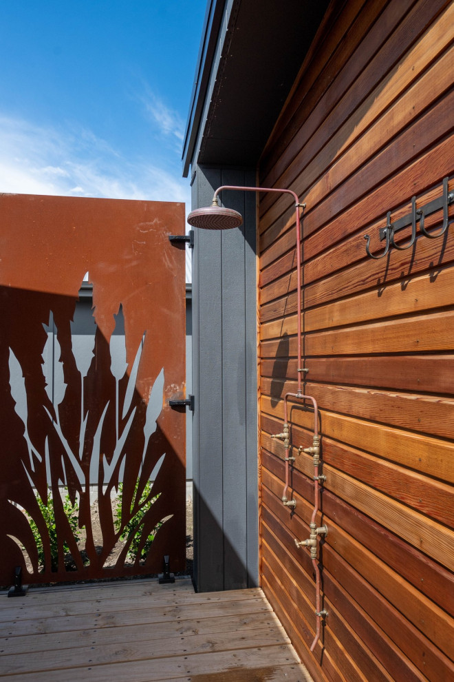Outdoor shower deck - large coastal backyard ground level outdoor shower deck idea with no cover