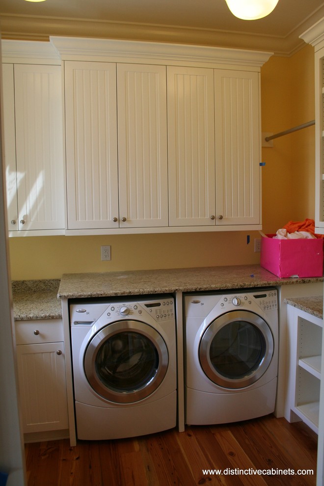 Inspiration for a traditional laundry room in Charlotte with recessed-panel cabinets and white cabinets.