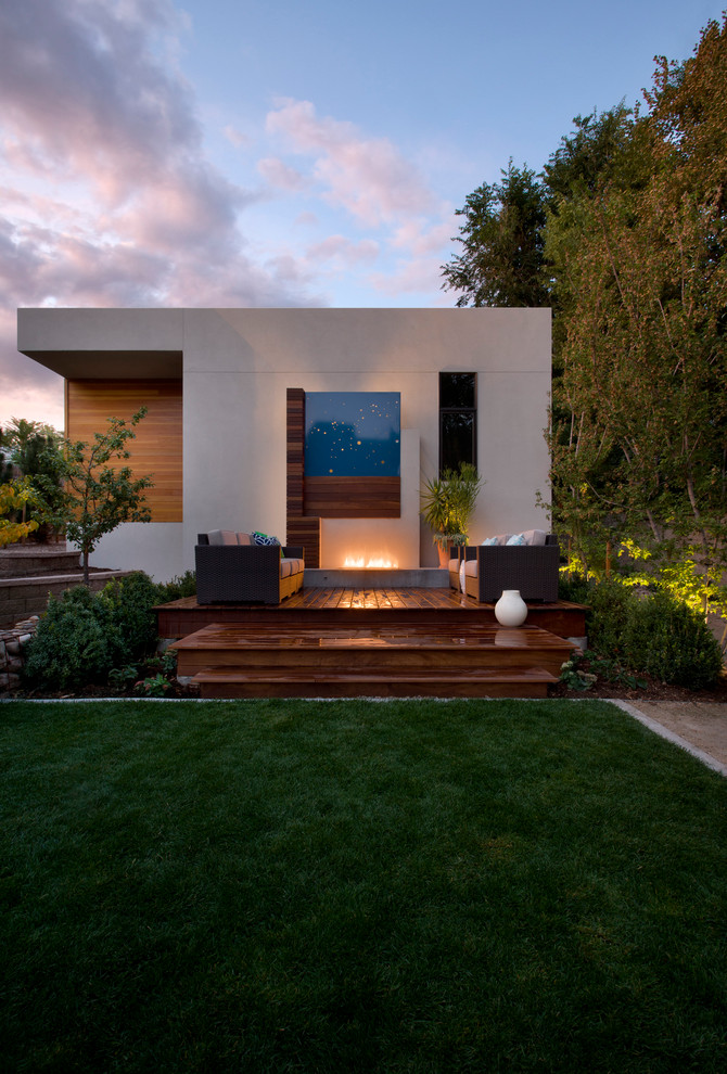 Contemporary backyard deck in Denver with a fire feature.