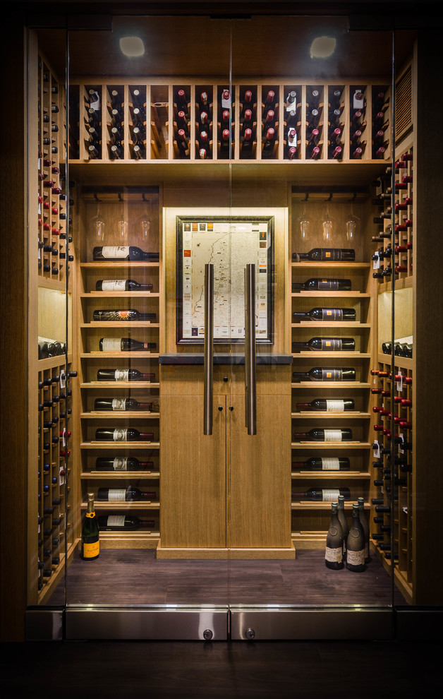 Inspiration for a small contemporary wine cellar in Toronto with dark hardwood floors and display racks.