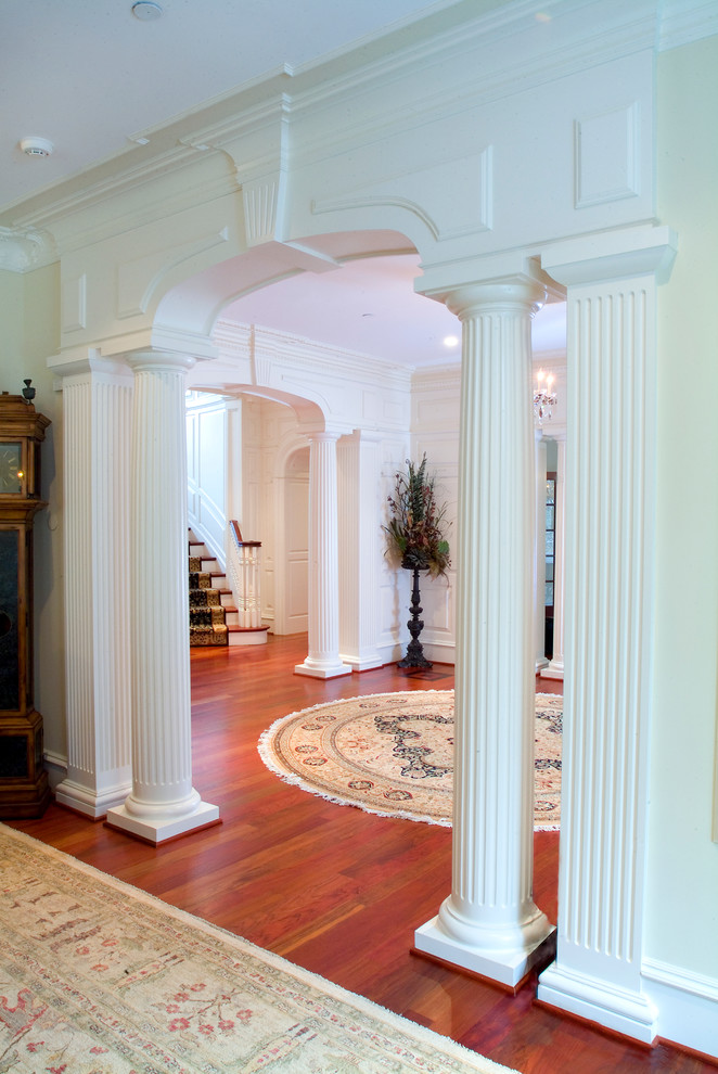 Inspiration for an expansive traditional foyer in Philadelphia with white walls, medium hardwood floors, a single front door and a medium wood front door.