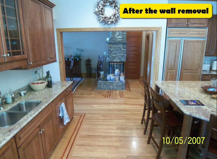 Example of a large u-shaped light wood floor and multicolored floor enclosed kitchen design in Baltimore with an undermount sink, beaded inset cabinets, medium tone wood cabinets, granite countertops, paneled appliances, an island and multicolored countertops