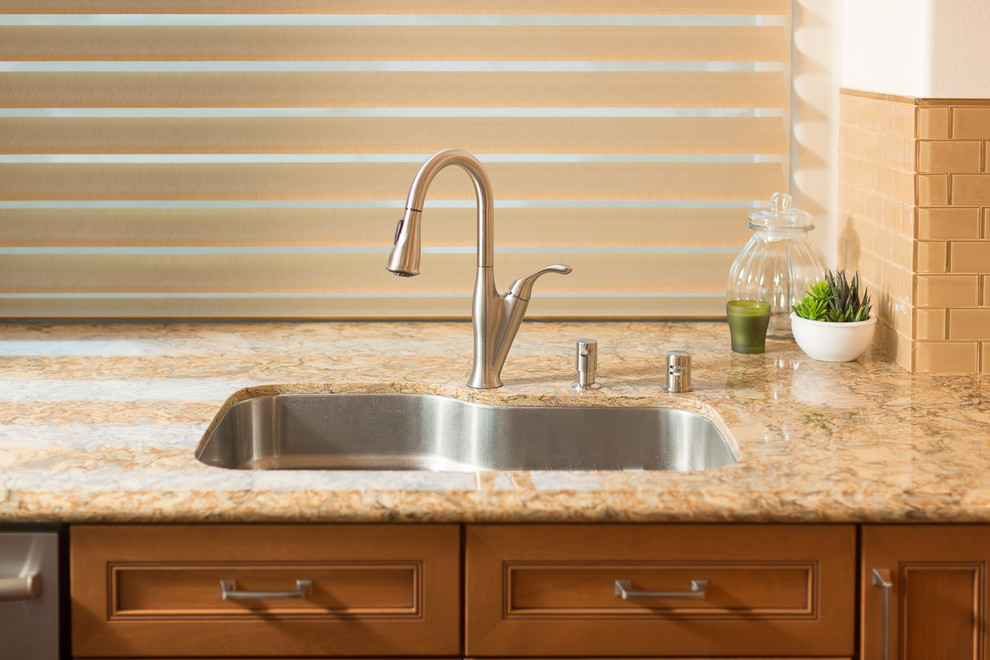 Example of a large transitional u-shaped dark wood floor eat-in kitchen design in Orange County with a single-bowl sink, raised-panel cabinets, medium tone wood cabinets, granite countertops, beige backsplash, ceramic backsplash, stainless steel appliances and no island