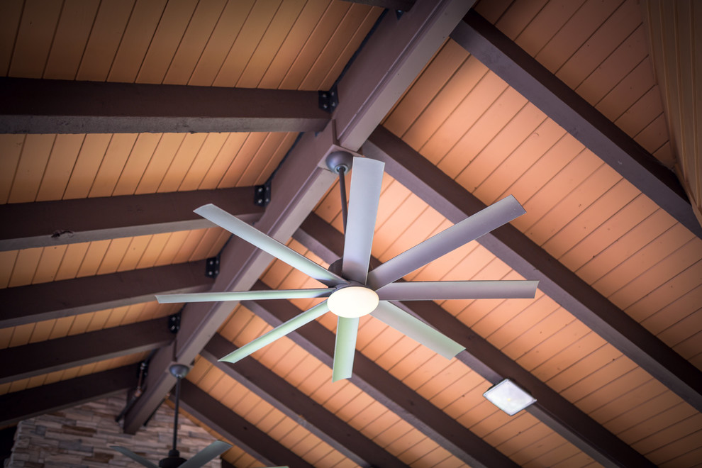 Inspiration for a huge rustic backyard home design remodel in Indianapolis with a roof extension