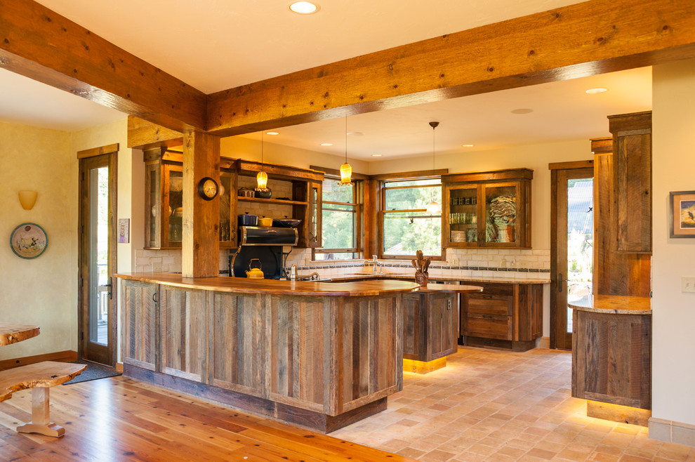 Large mountain style u-shaped cement tile floor and beige floor open concept kitchen photo in Seattle with recessed-panel cabinets, granite countertops, beige backsplash, ceramic backsplash, stainless steel appliances, an island, an undermount sink and dark wood cabinets
