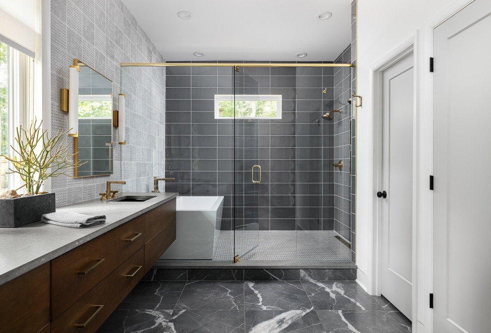 Photo of a midcentury master wet room bathroom in Atlanta with flat-panel cabinets, dark wood cabinets, a freestanding tub, gray tile, grey walls, an undermount sink, grey floor, a hinged shower door, grey benchtops, a double vanity and a floating vanity.