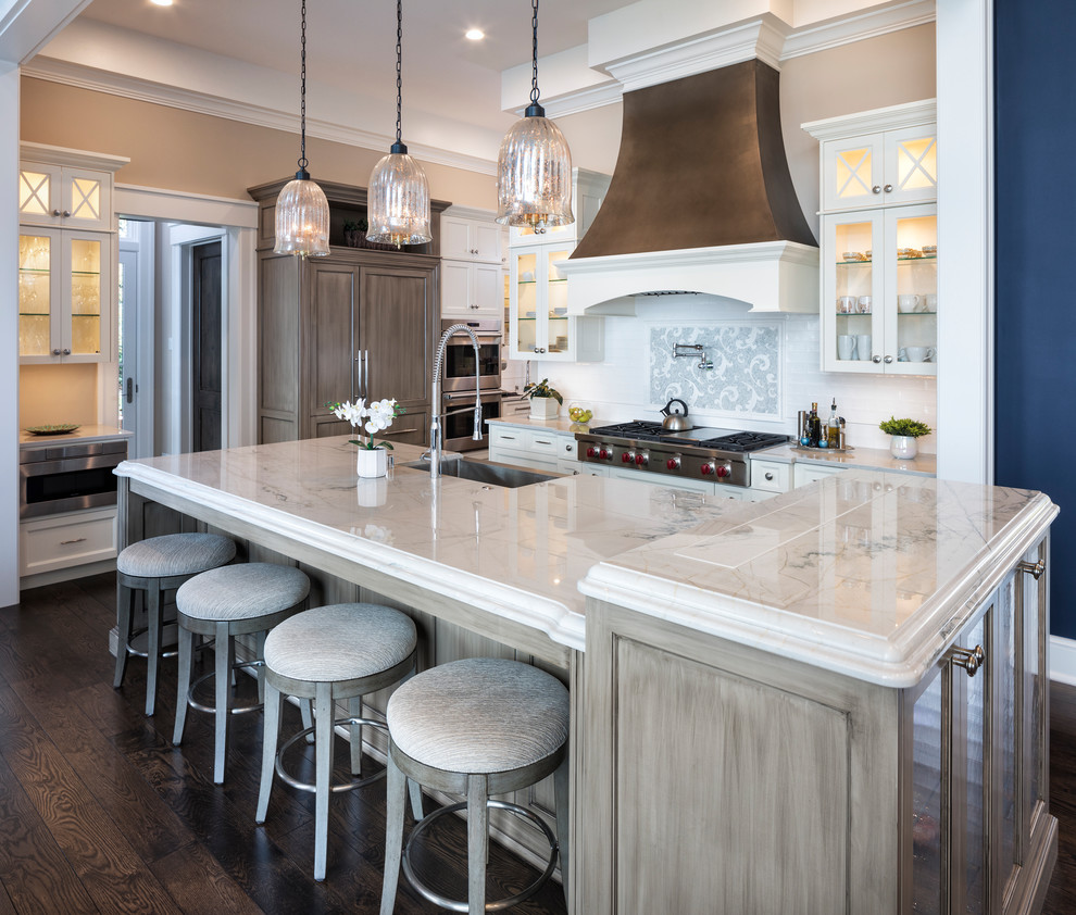 Inspiration for a large transitional l-shaped brown floor eat-in kitchen remodel in Minneapolis with a single-bowl sink, quartzite countertops, stainless steel appliances, white backsplash, marble backsplash and an island
