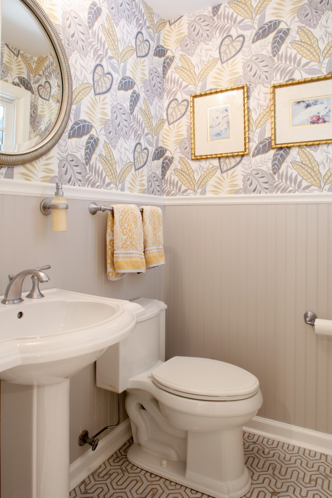 Photo of a world-inspired cloakroom in New York with mosaic tile flooring, a pedestal sink and wallpapered walls.