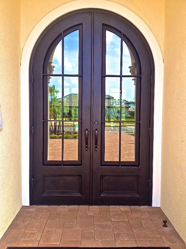 Photo of a large traditional front door in Miami with a double front door and a metal front door.