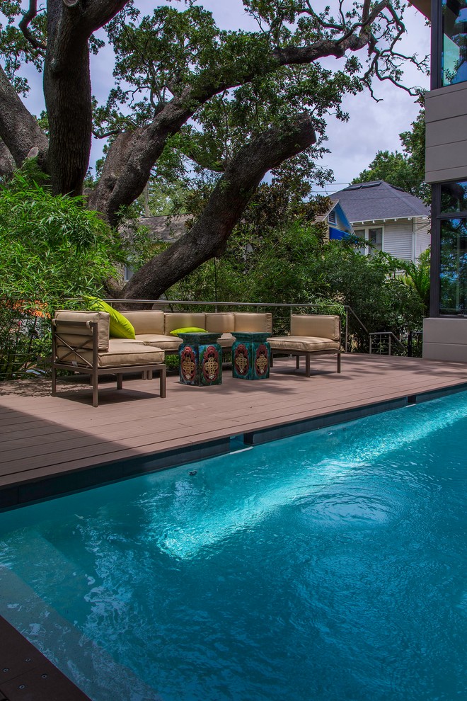 Design ideas for a small modern side yard rectangular pool in Tampa with decking.
