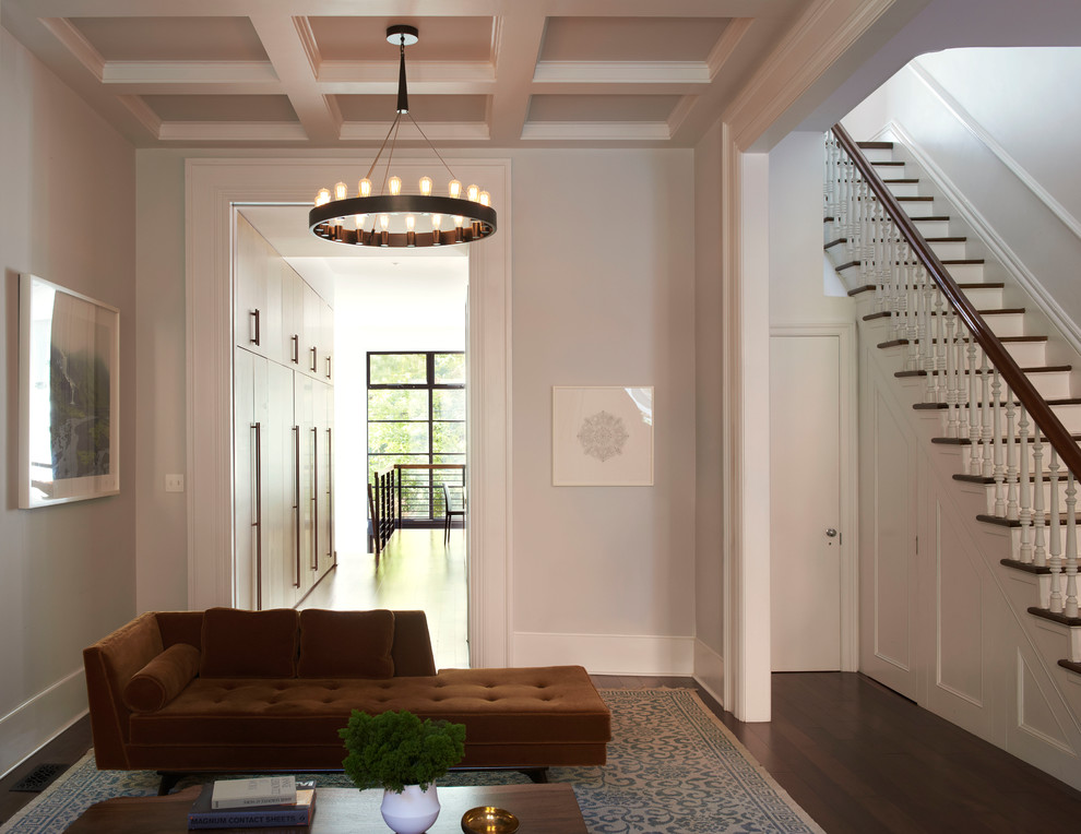 Photo of a transitional formal living room in New York with white walls, medium hardwood floors and brown floor.