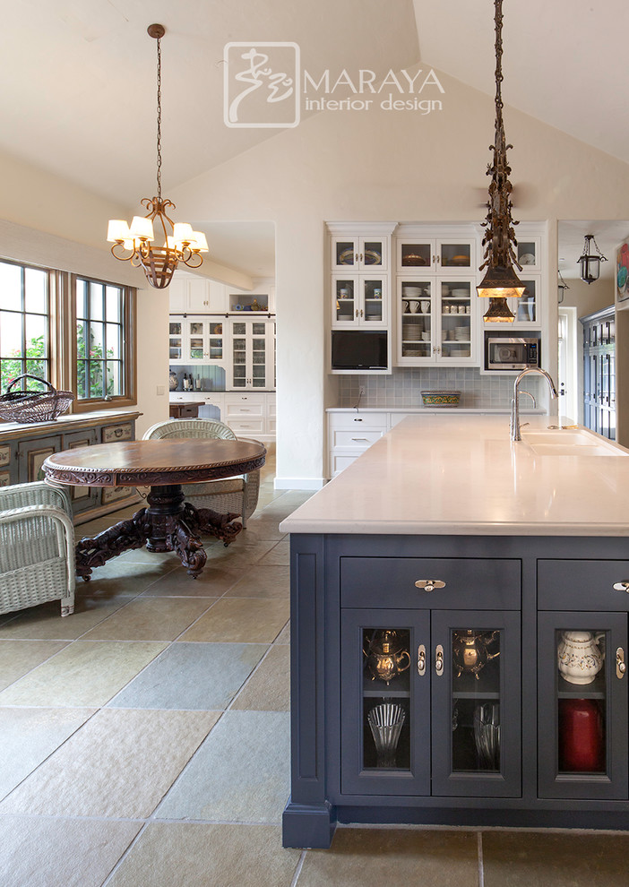 Inspiration for an expansive traditional kitchen pantry in Santa Barbara with a farmhouse sink, recessed-panel cabinets, white cabinets, quartz benchtops, timber splashback, slate floors, with island, green floor and black benchtop.