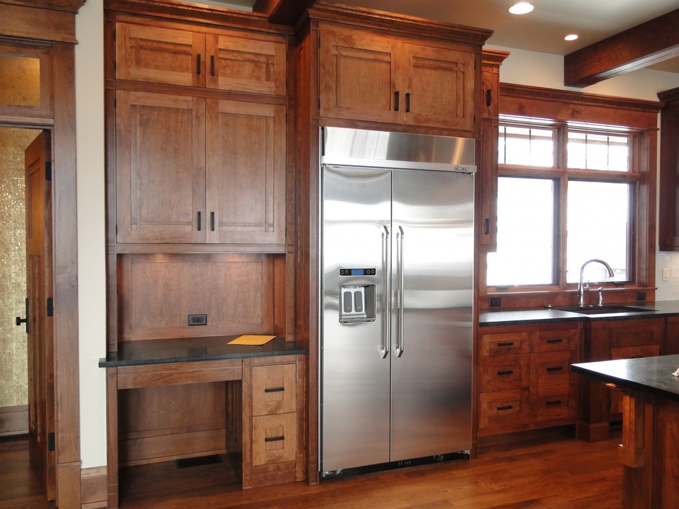 Huge mountain style kitchen photo in Denver with soapstone countertops and an island