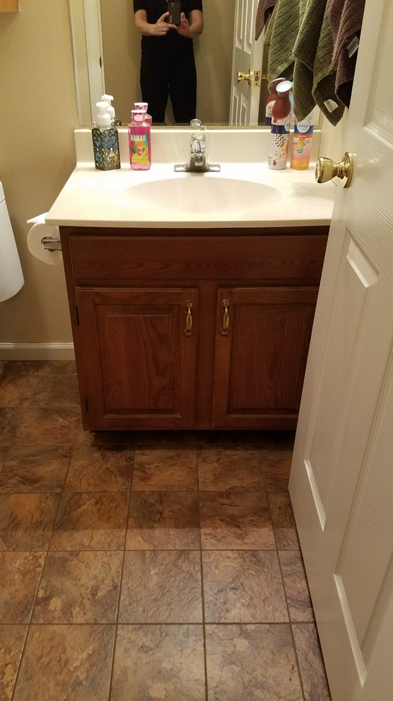 Example of a small mountain style kids' gray tile and porcelain tile porcelain tile and gray floor home design design with furniture-like cabinets, distressed cabinets, a two-piece toilet, gray walls, an undermount sink, granite countertops and a hinged shower door