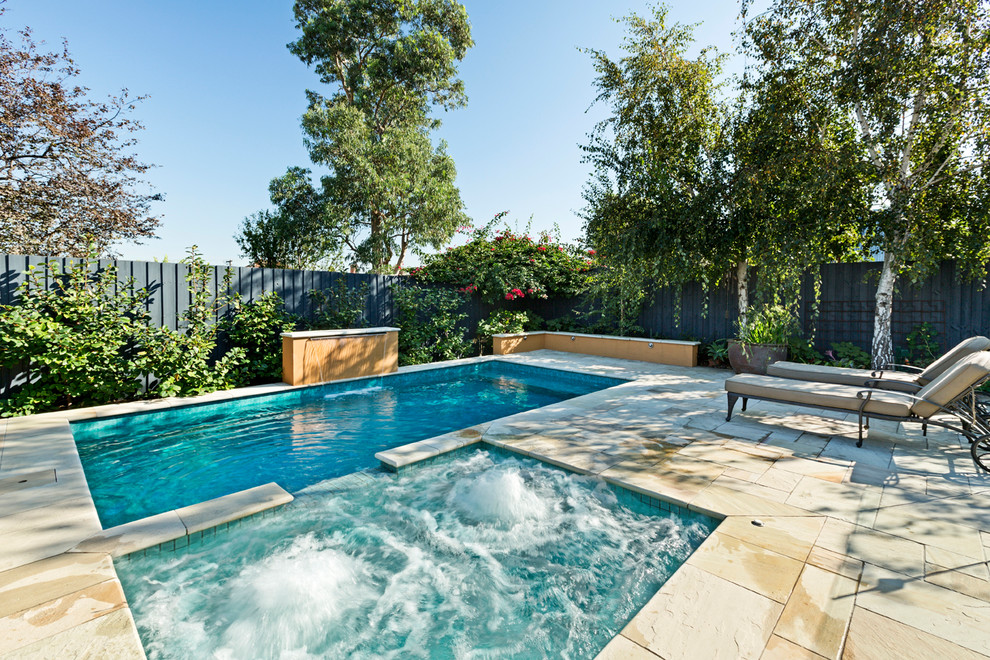 Photo of a small victorian backyard rectangular natural pool in Melbourne with a hot tub and natural stone pavers.