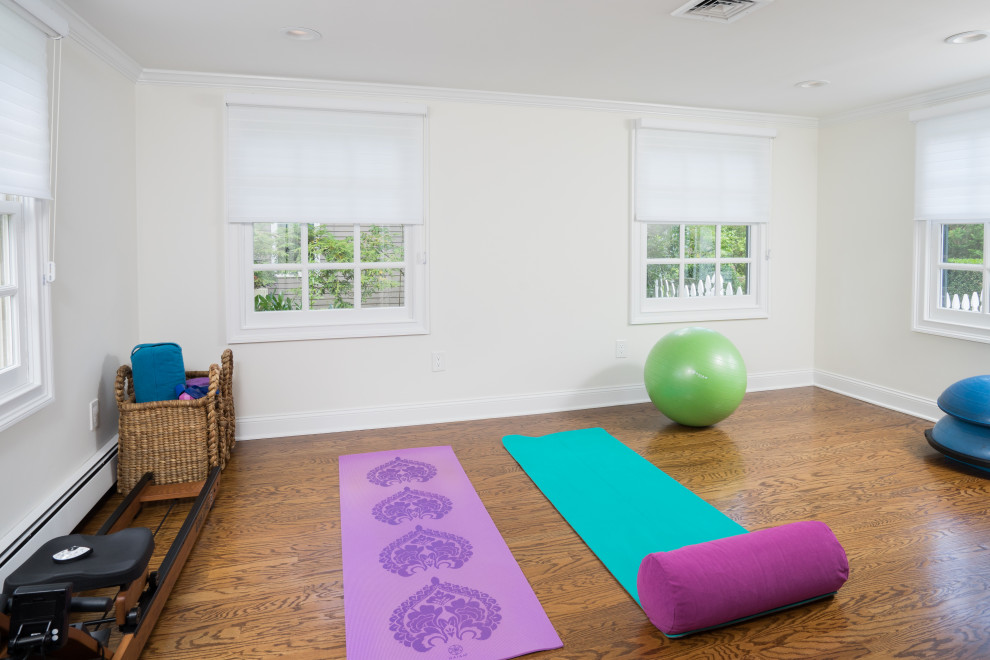 Small transitional home yoga studio in Philadelphia with white walls, medium hardwood floors and brown floor.