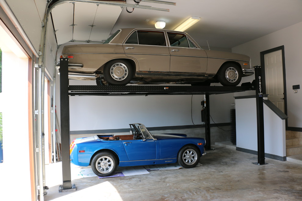 Example of a mid-sized minimalist attached three-car garage design in Austin