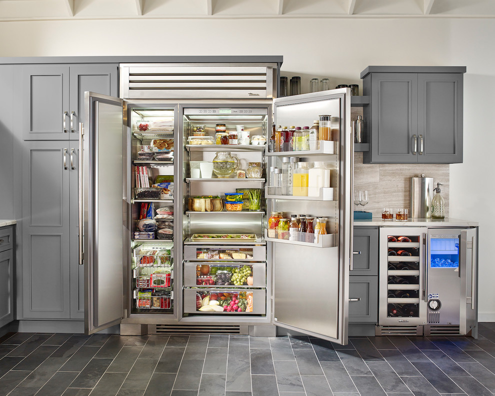 Enclosed kitchen - mid-sized transitional l-shaped ceramic tile and gray floor enclosed kitchen idea in St Louis with an undermount sink, recessed-panel cabinets, gray cabinets, granite countertops, beige backsplash, porcelain backsplash, stainless steel appliances and an island