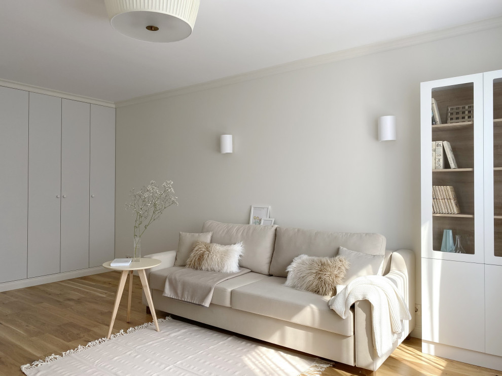 Photo of a medium sized contemporary grey and white enclosed living room in Moscow with a reading nook, beige walls, medium hardwood flooring, no fireplace, a wall mounted tv, beige floors and feature lighting.