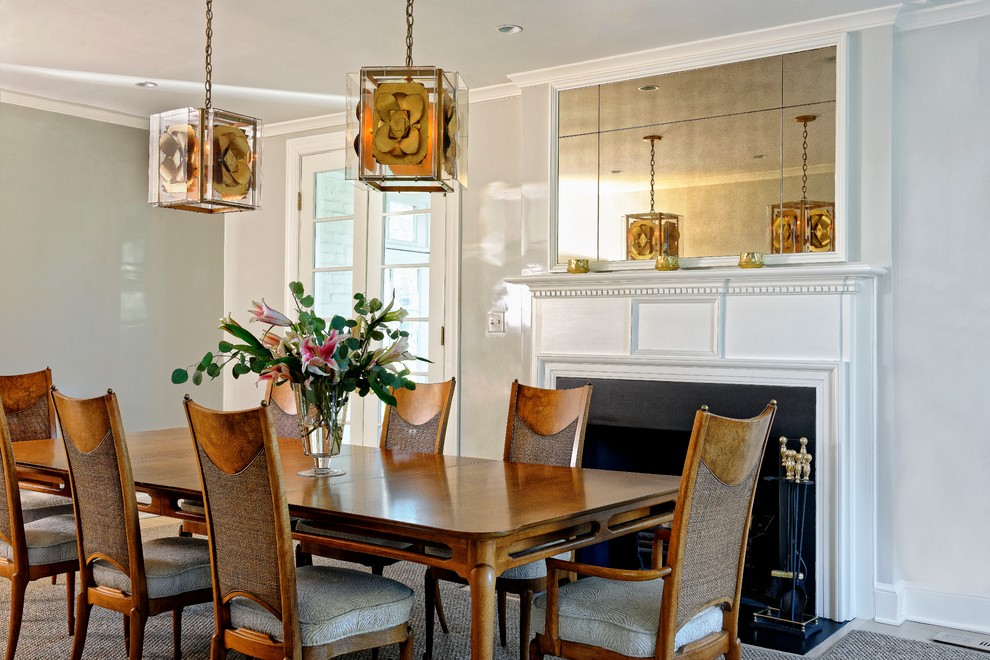 This is an example of a transitional separate dining room in DC Metro with grey walls and a standard fireplace.