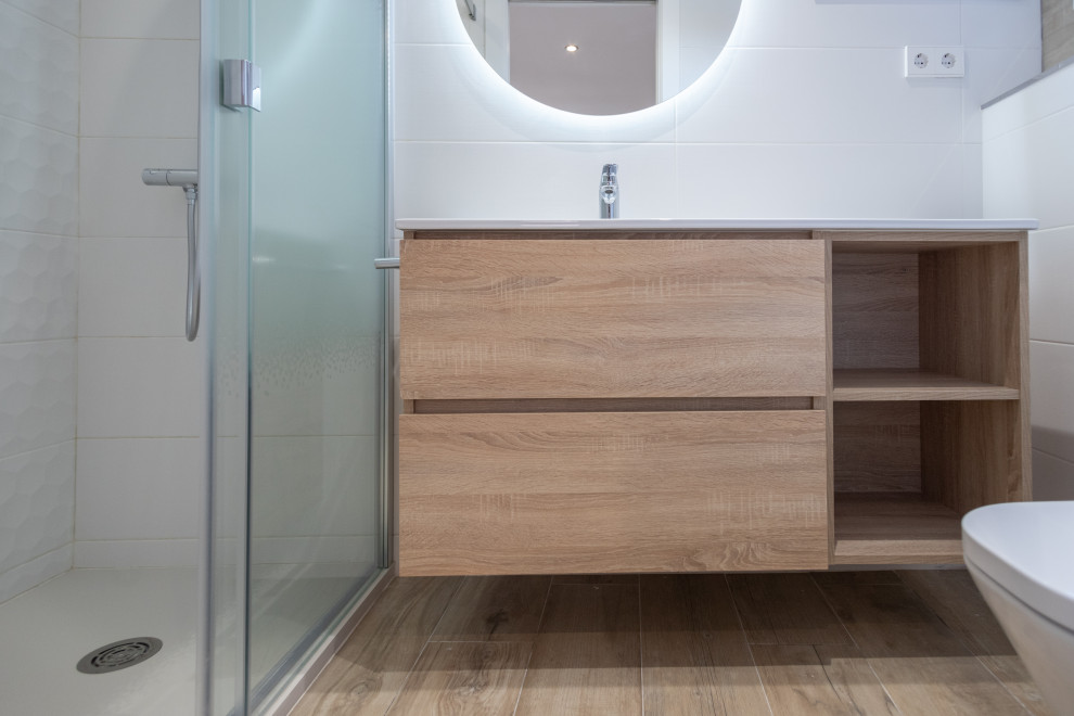 Mid-sized mediterranean master bathroom in Barcelona with flat-panel cabinets, medium wood cabinets, a curbless shower, a two-piece toilet, beige tile, ceramic tile, ceramic floors, a trough sink, brown floor, a sliding shower screen, white benchtops, an enclosed toilet, a single vanity and a floating vanity.