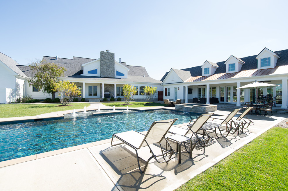 Inspiration for a large transitional backyard concrete and rectangular pool house remodel