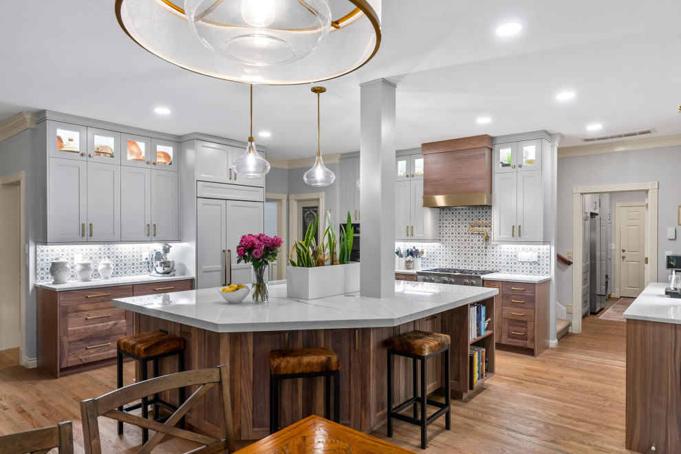This is an example of a large contemporary u-shaped eat-in kitchen in Seattle with recessed-panel cabinets, quartzite benchtops and with island.
