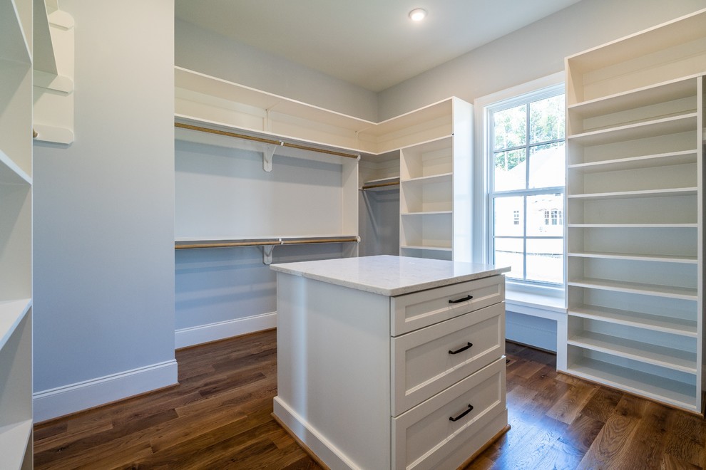 Inspiration for a mid-sized modern storage and wardrobe in Raleigh with white cabinets and medium hardwood floors.