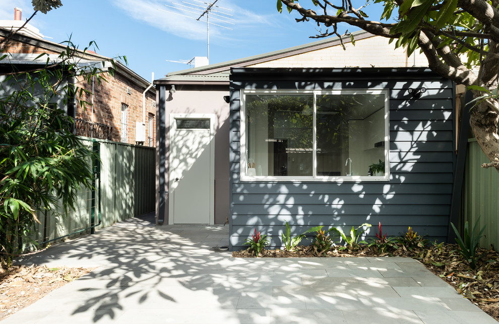 Inspiration for a small contemporary one-storey grey house exterior in Sydney with concrete fiberboard siding.
