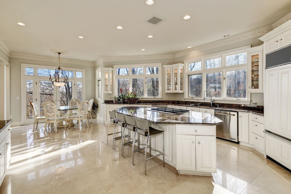 Photo of a large transitional kitchen in DC Metro with granite benchtops, stainless steel appliances, marble floors, with island, white floor and brown benchtop.