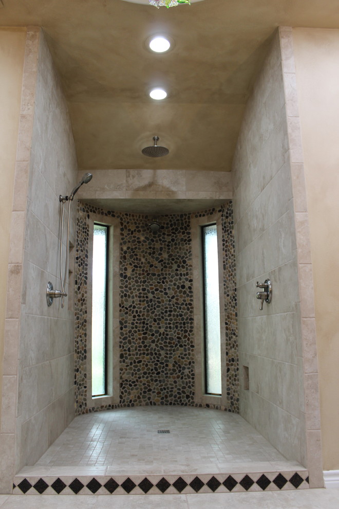Expansive mediterranean master bathroom in Other with recessed-panel cabinets, brown cabinets, an open shower, a two-piece toilet, multi-coloured tile, pebble tile, multi-coloured walls, porcelain floors, an undermount sink, granite benchtops, multi-coloured floor and an open shower.