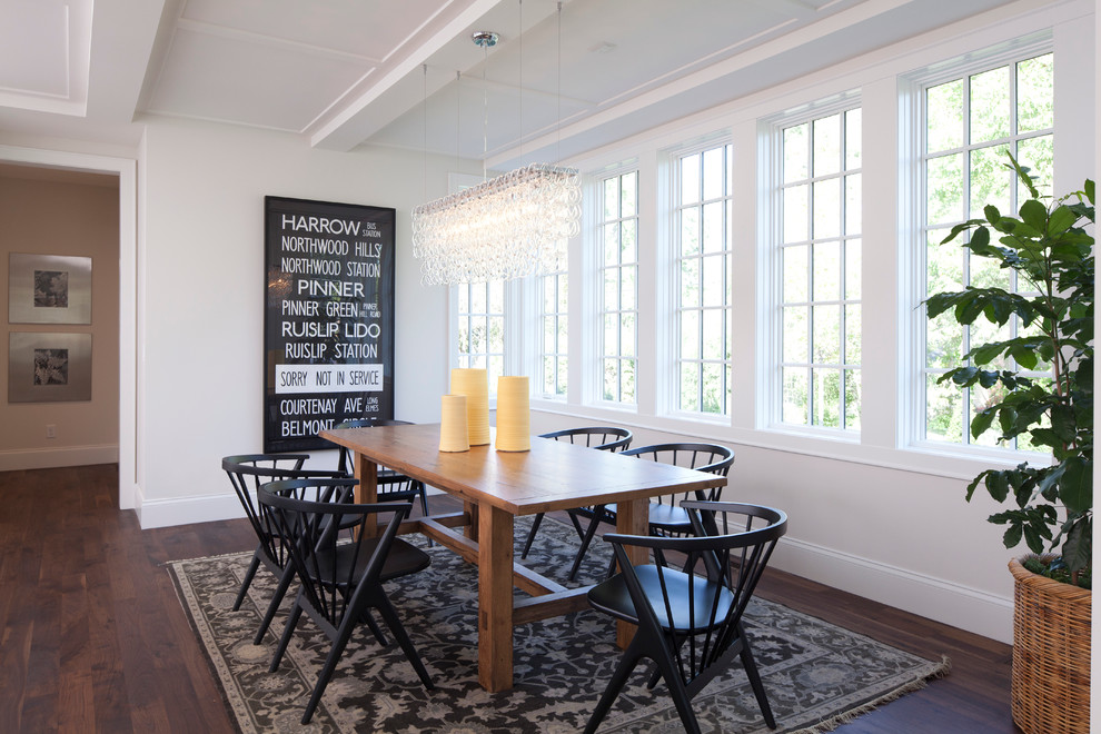 This is an example of a transitional dining room in Minneapolis with white walls and dark hardwood floors.
