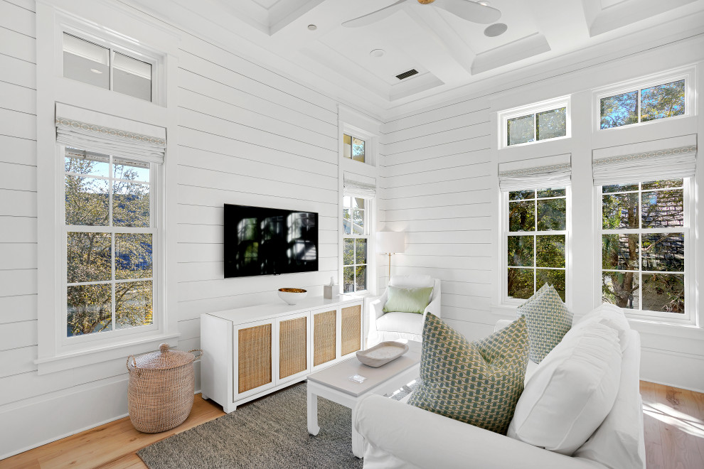 Photo of an expansive beach style guest bedroom in Other with white walls, light hardwood floors, beige floor, timber and planked wall panelling.