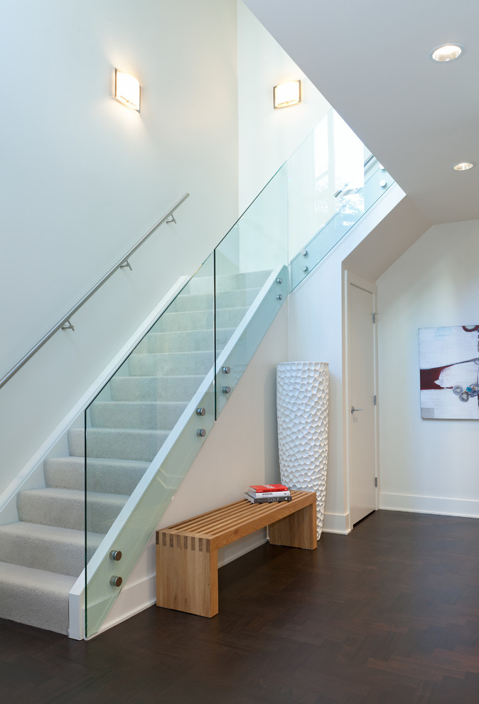 Photo of a contemporary carpeted l-shaped staircase in Vancouver with carpet risers.