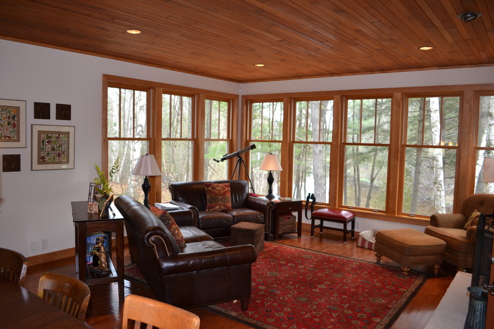 This is an example of a mid-sized country formal open concept living room in Other with white walls, dark hardwood floors and no tv.