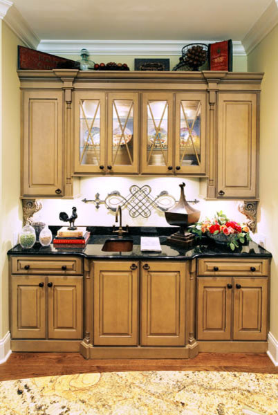 Example of a mid-sized transitional medium tone wood floor kitchen design in Indianapolis with a drop-in sink, raised-panel cabinets, light wood cabinets and granite countertops