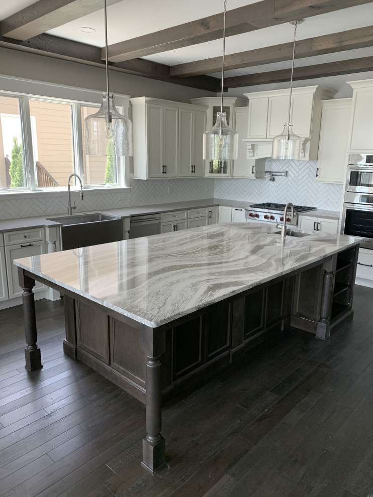 Large transitional l-shaped open plan kitchen in Other with an undermount sink, shaker cabinets, white cabinets, quartz benchtops, white splashback, ceramic splashback, stainless steel appliances, with island and multi-coloured benchtop.