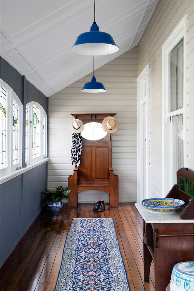 Design ideas for a transitional entryway in Brisbane with grey walls, medium hardwood floors and brown floor.