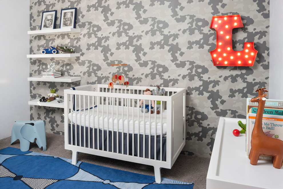 This is an example of a contemporary gender-neutral nursery in Orange County with grey walls, carpet and grey floor.