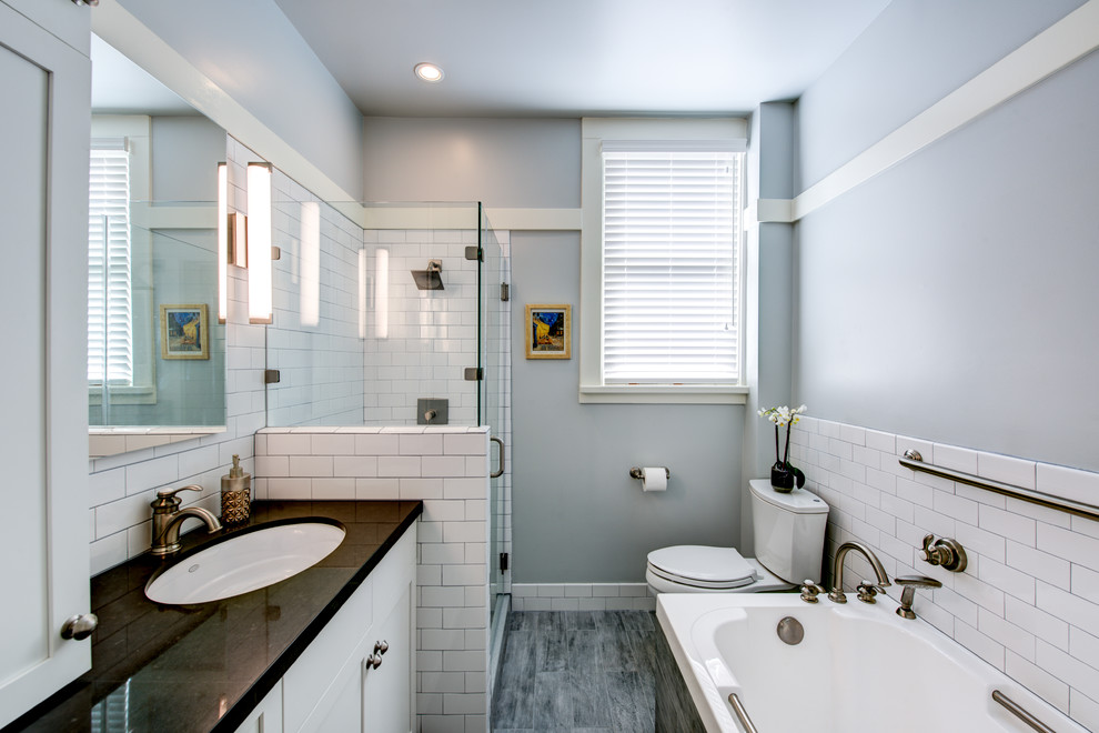 Mid-sized traditional bathroom in San Francisco with an undermount sink, shaker cabinets, white cabinets, a corner tub, a corner shower, a two-piece toilet, white tile, subway tile, grey walls and porcelain floors.