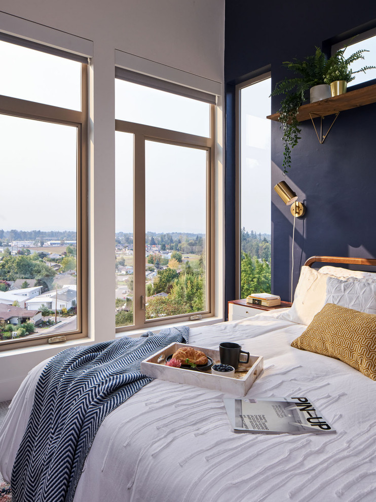 Imagen de dormitorio principal y abovedado moderno de tamaño medio con paredes azules, moqueta y suelo gris