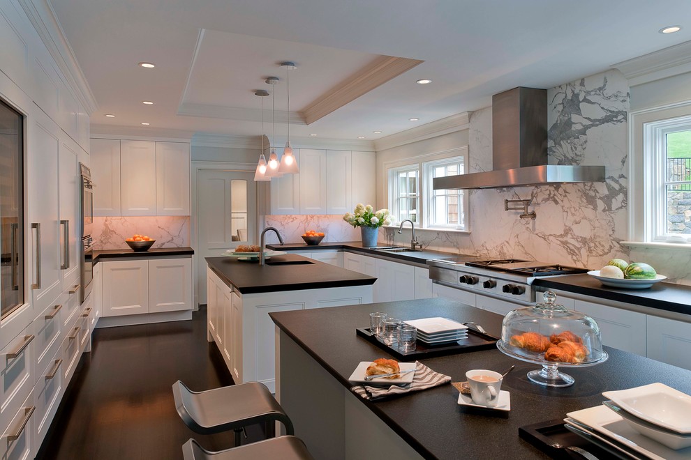 Traditional eat-in kitchen in New York with recessed-panel cabinets, white cabinets and white splashback.