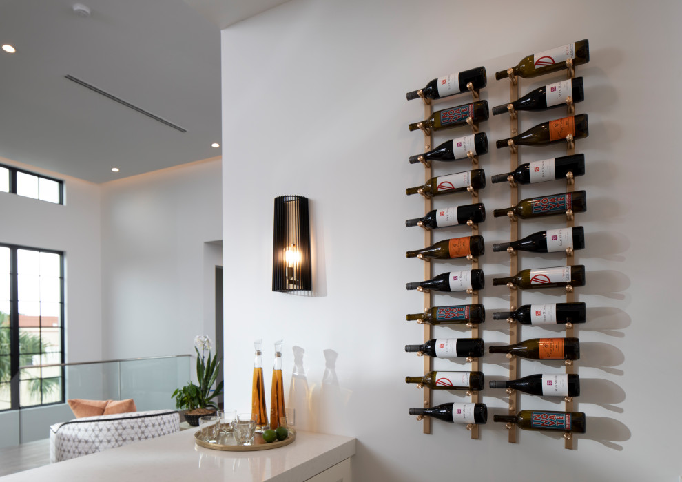 This is an example of a small contemporary wine cellar in Orlando with display racks.