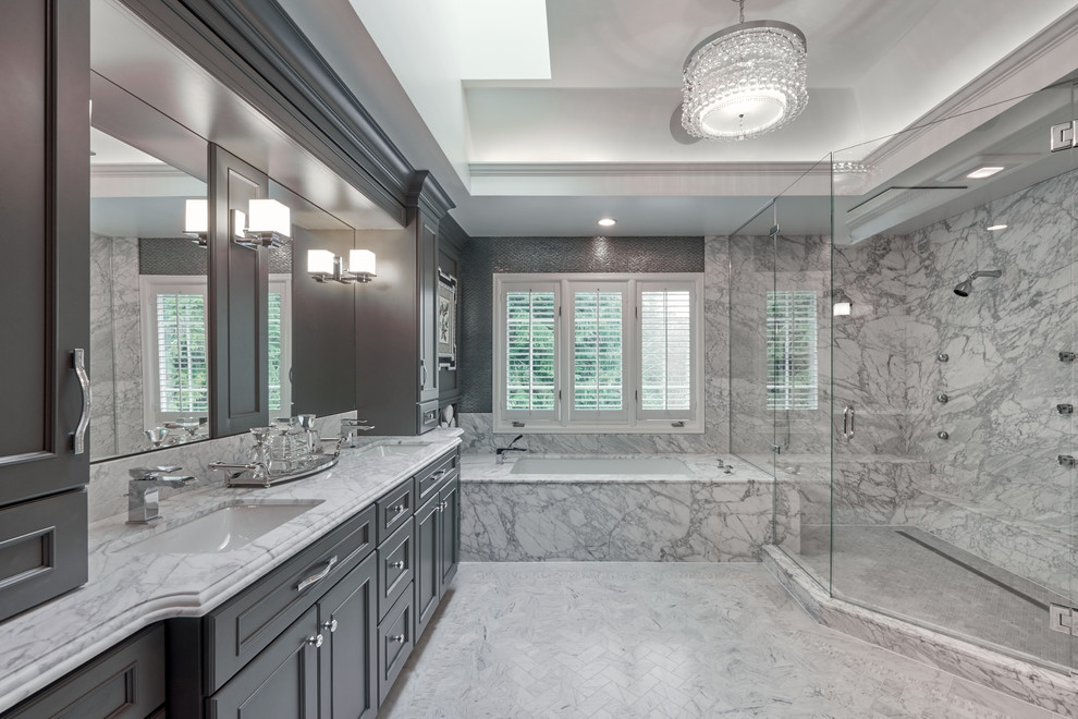 Photo of a mid-sized traditional master wet room bathroom in Seattle with shaker cabinets, marble floors, an undermount sink, granite benchtops, grey benchtops, grey cabinets, an alcove tub, grey walls, grey floor and a hinged shower door.